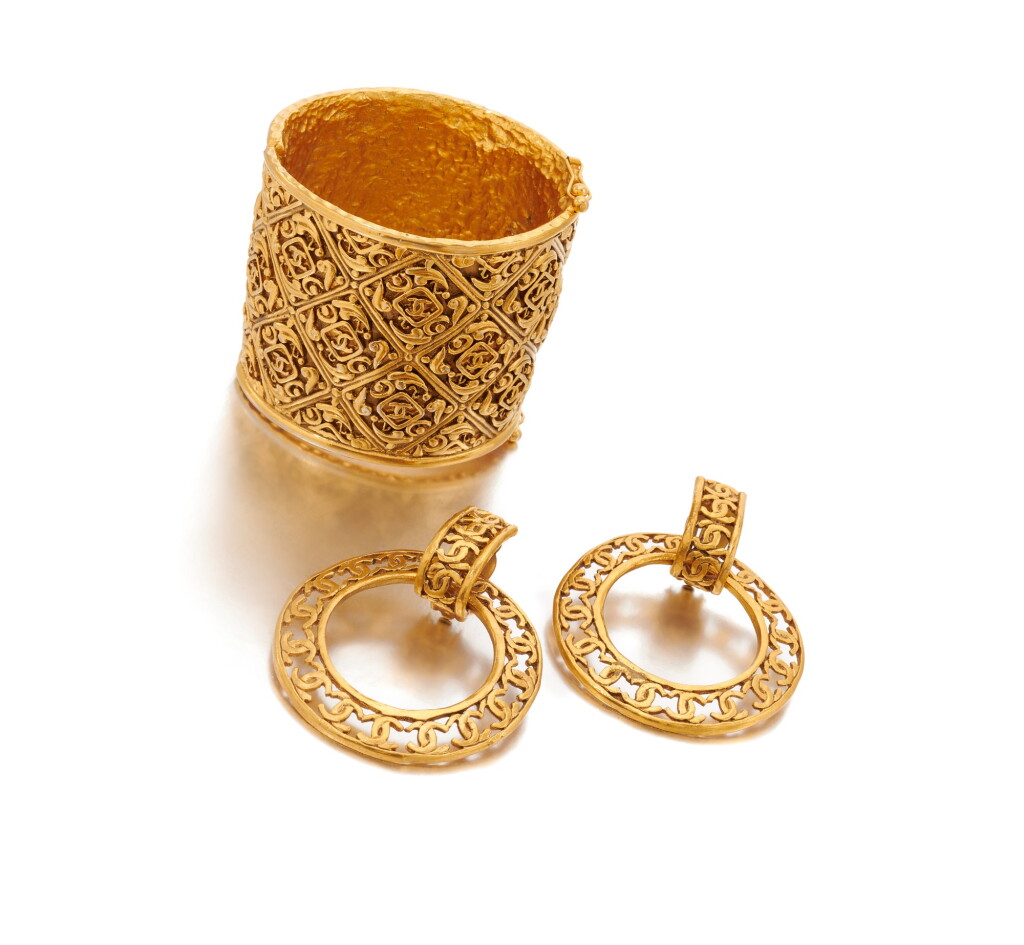 View full screen - View 1 of Lot 67. Gold-tone metal cuff and pair of earrings.