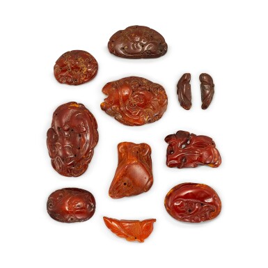 View full screen - View 1 of Lot 1036. A GROUP OF ELEVEN AMBER ORNAMENTS LIAO - JIN DYNASTY | 遼至金 琥珀佩飾一組十一件.