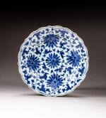 A large blue and white barbed-rim 'lotus' dish, Qing dynasty, 17th century | 清十七世紀 青花纏枝蓮紋菱口折沿盤