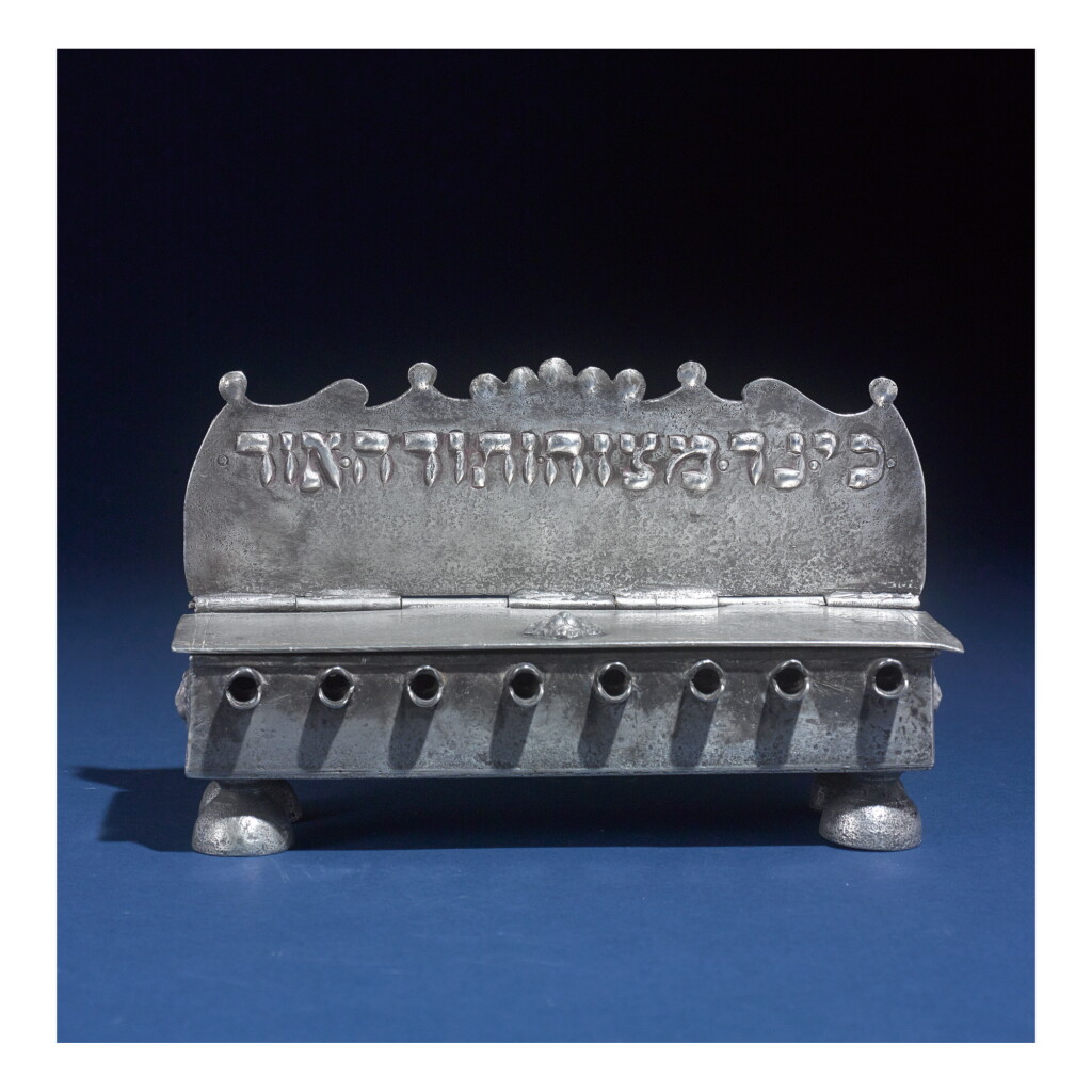 View full screen - View 1 of Lot 66. A CONTINENTAL PEWTER BENCH-FORM HANUKAH LAMP, SWISS OR FRENCH, EARLY 19TH CENTURY.