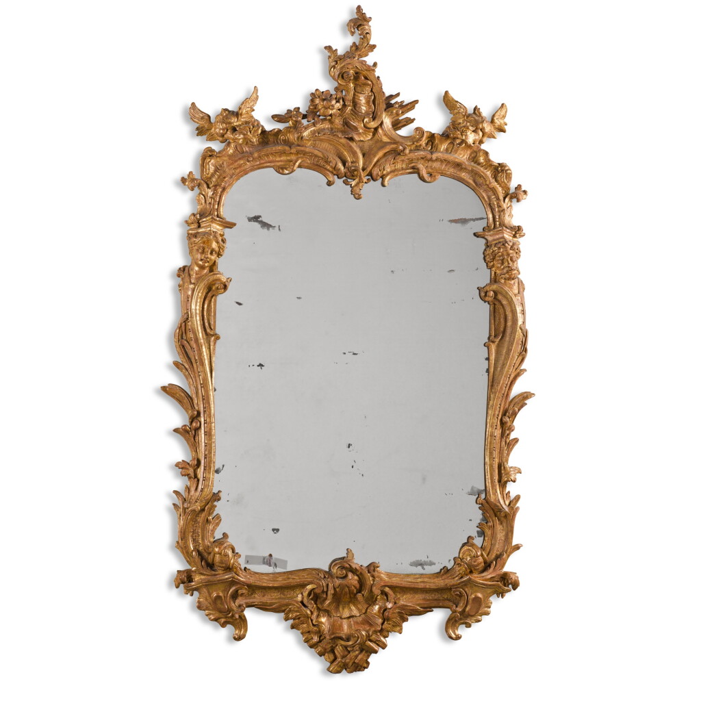 View full screen - View 1 of Lot 5. A George II carved giltwood mirror, circa 1750, in the manner of Matthias Lock.