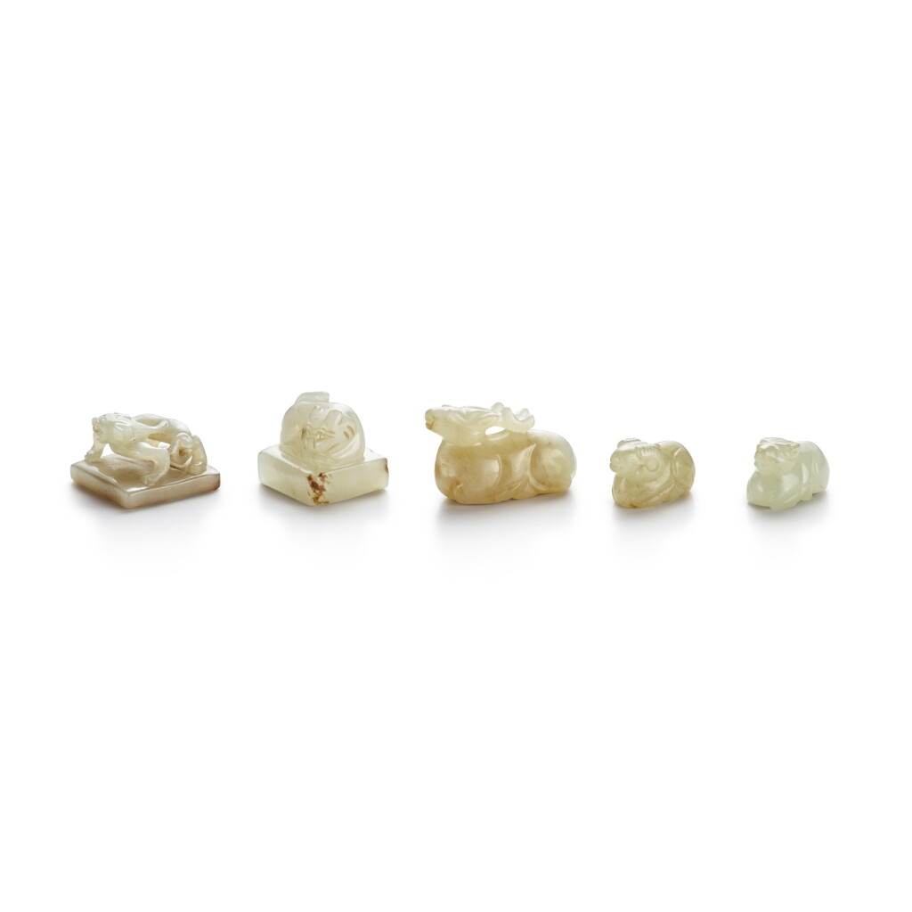 View full screen - View 1 of Lot 148. Two small pale celadon jade seals and three small pale celadon jade carvings of animals, 19th / 20th century.