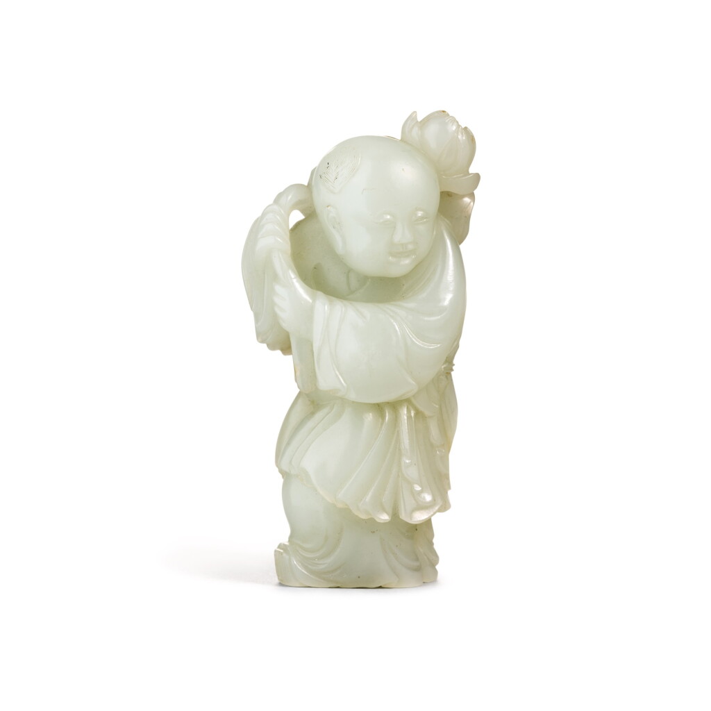 View full screen - View 1 of Lot 211. A PALE CELADON JADE FIGURE OF A BOY, QING DYNASTY, 18TH CENTURY | 清十八世紀 青白玉持蓮童子.