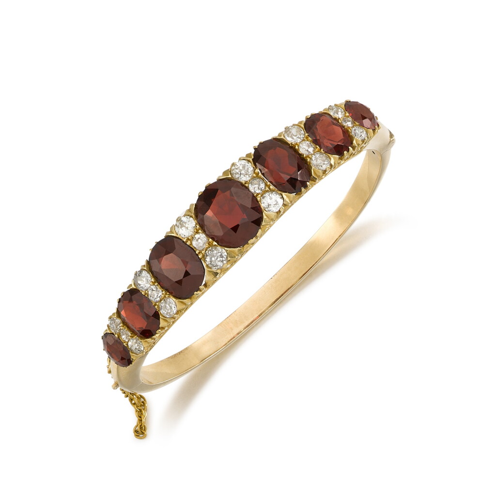 View full screen - View 1 of Lot 19. Garnet and diamond bangle, late 19th century.