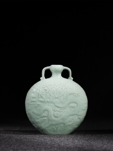 View full screen - View 1 of Lot 3634. A superb and possibly unique celadon-glazed 'dragon' moon flask, Seal mark and period of Qianlong | 清乾隆 粉青釉浮雕海水龍紋雙耳扁壺 《大清乾隆年製》款.