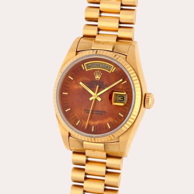 View full screen - View 1 of Lot 94. Day-Date, Reference 18038 | A yellow gold wristwatch with day, date, bracelet and burl wood dial | Circa 1979.