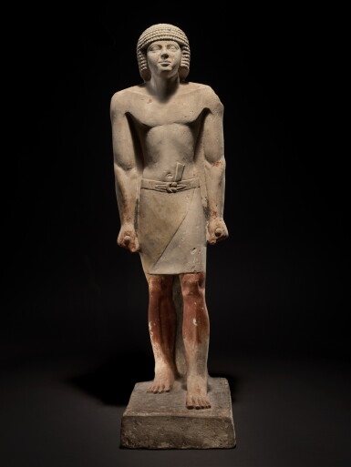 View full screen - View 1 of Lot 17. An Egyptian Limestone Figure of a Man, late 5th Dynasty, circa 2440-2355 B.C..