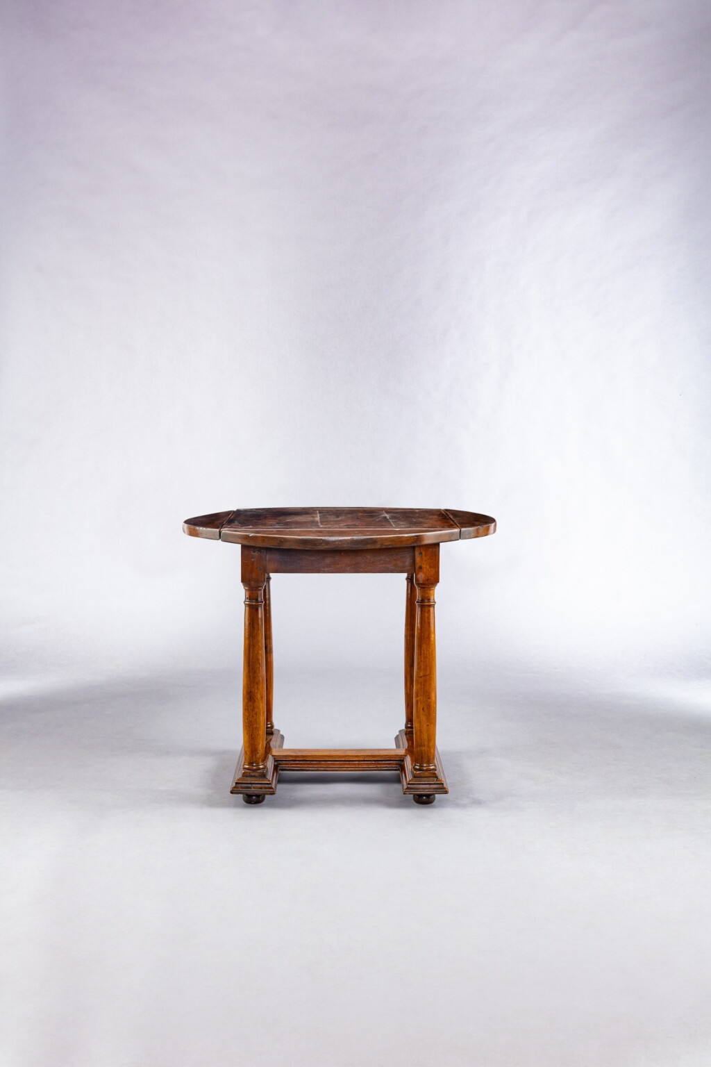 View full screen - View 1 of Lot 523. An Italian walnut drop-leaf table, probably Tuscan, in the 16th-century style .