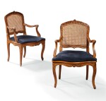 A pair of carved and caned beechwood armchairs, Louis XV, mid-18th century | Paire de fauteuils en bois de hêtre sculpté et canné, d'époque Louis XV