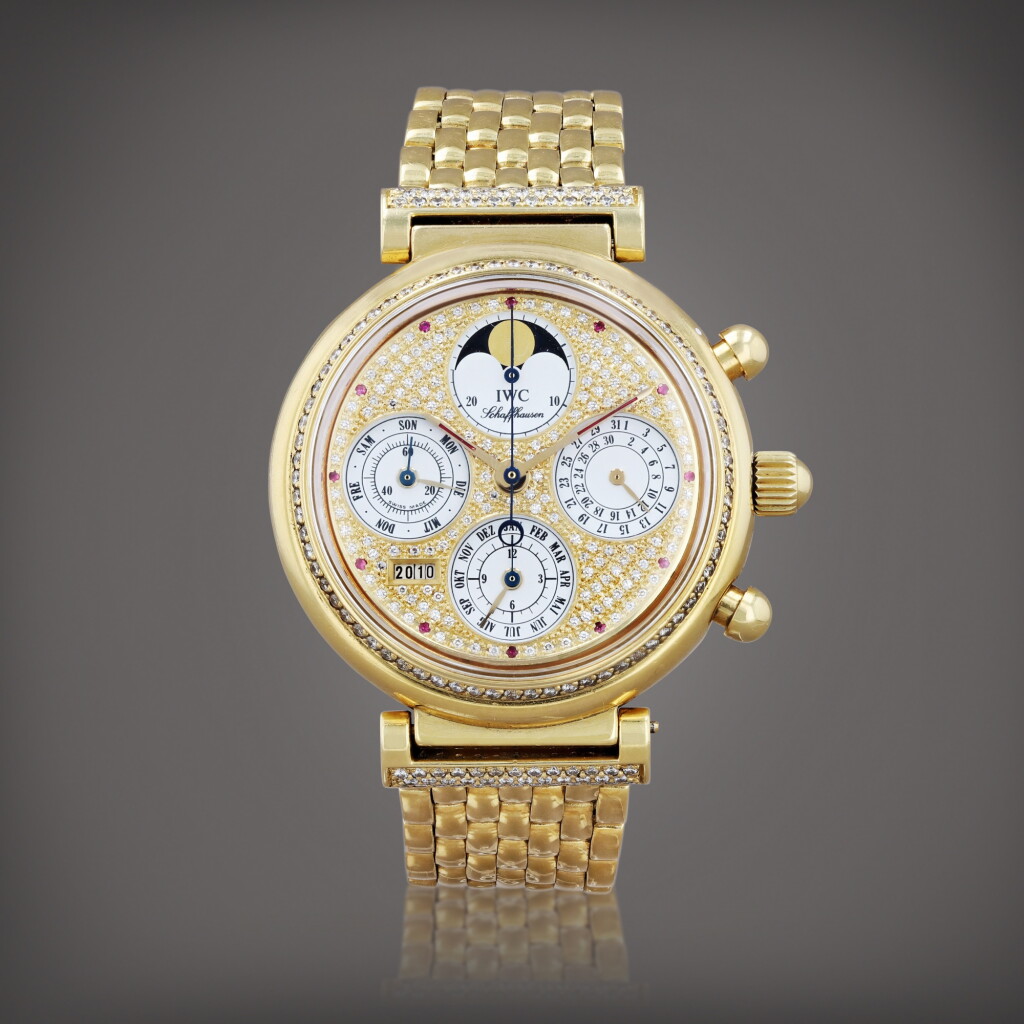 View full screen - View 1 of Lot 456. Montre bracelet chronographe en or jaune sertie de diamants et rubis avec quantième perpétuel et phases de lune | Yellow gold, diamond and ruby-set chronograph wristwatch with perpetual calendar, moon phases and bracelet Vers 1993 | Circa 1993.