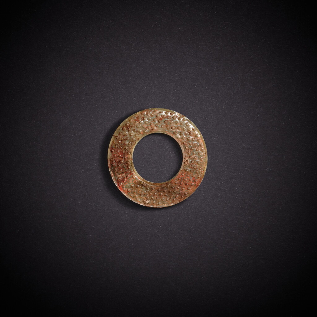 View full screen - View 1 of Lot 7873. A pale celadon and russet jade disc, huan, Eastern Zhou dynasty, Warring States period | 東周戰國 青白玉穀紋環.