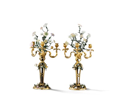 View full screen - View 1 of Lot 52. A pair of Louis XV three-light gilt-bronze, painted metal and porcelain flower candelabra, circa 1750, attributed to the marchand-mercier Machart | Paire de candélabres à trois lumières en bronze doré et fleurs de porcelaine, vers 1750, attribuée au marchand-mercier Machart .