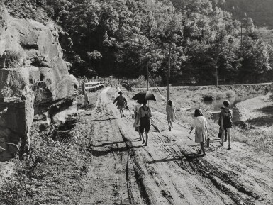 View full screen - View 1 of Lot 917. Going home from school. In Breathitt County, Kentucky. The school year begins in July and ends in January, as most of the children have no shoes and insufficient clothing to walk the long distances over bad roads and up creek beds..