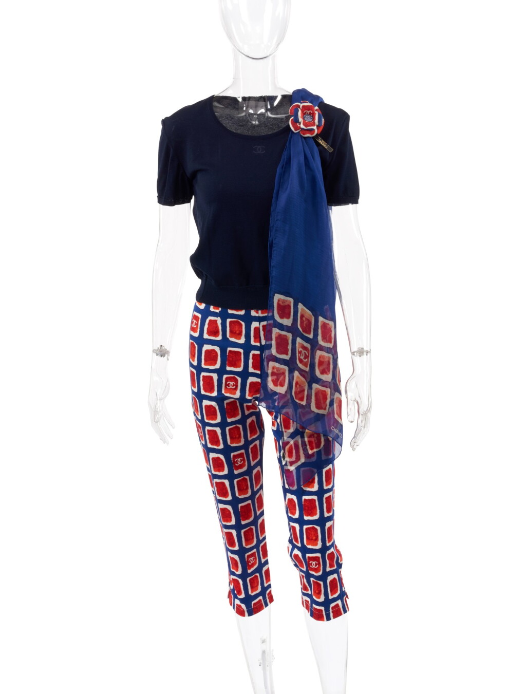 View full screen - View 1 of Lot 172. CHANEL | NAVY BLUE AND RED COTTON-BLEND TROUSERS, BROOCH AND FOULARD AND BLUE T-SHIRT .