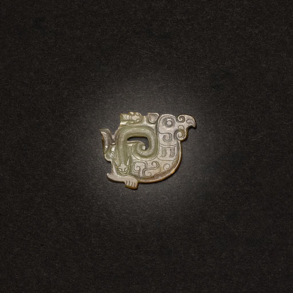 View full screen - View 1 of Lot 4. A celadon jade 'bird and snake' plaque, Eastern Zhou dynasty, Warring States period.