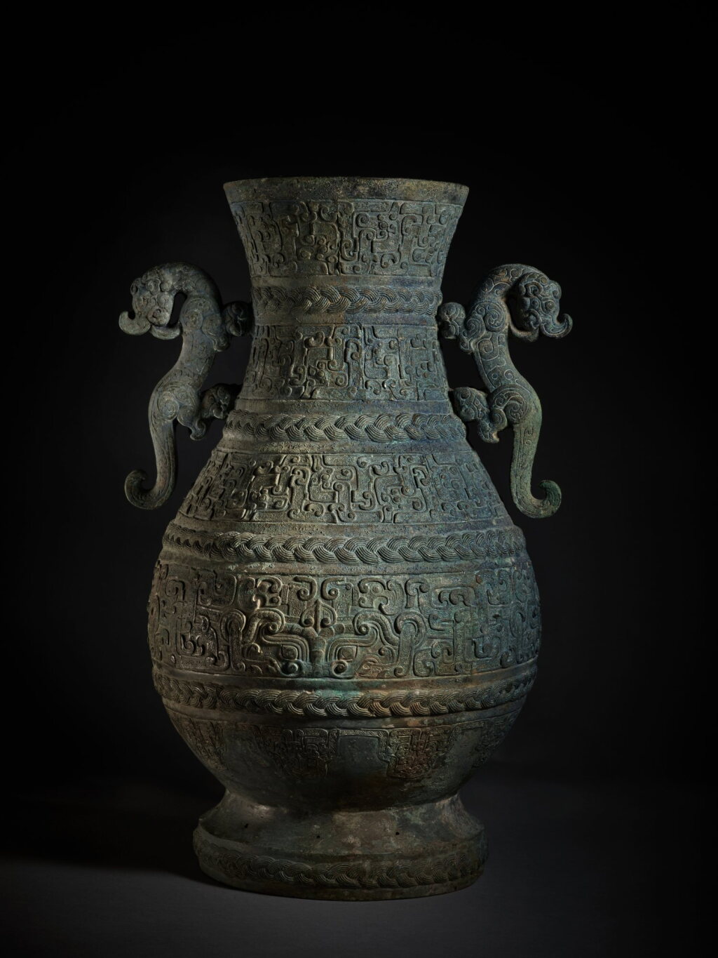 View full screen - View 1 of Lot 24. An exceptional and rare archaic bronze wine vessel (Hu), Eastern Zhou dynasty, Spring and Autumn period | 東周 春秋 青銅交龍紋壺.