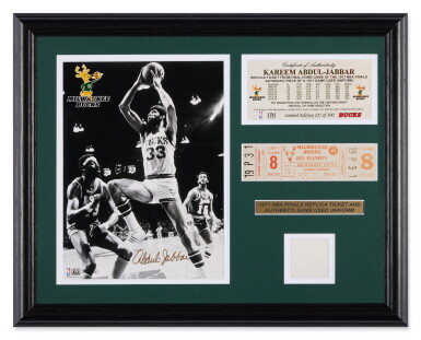 View full screen - View 1 of Lot 4. Kareem Abdul-Jabbar Milwaukee Bucks Signed Photo, Replica 1971 NBA Finals Ticket, and Game Worn Jersey Piece.