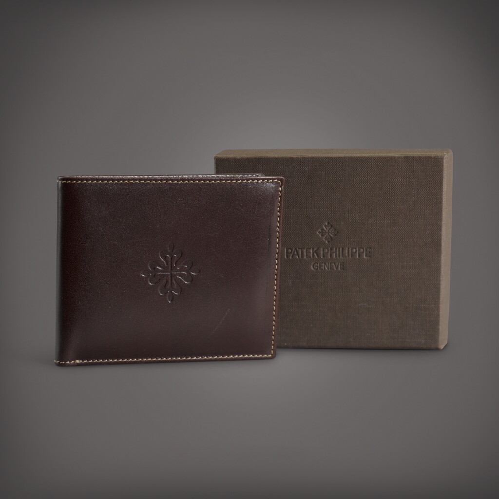 View full screen - View 1 of Lot 87. A brown calf leather bifold wallet | Circa 2018.