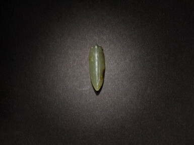 View full screen - View 1 of Lot 2. A green and russet jade 'cicada' pendant, Western Zhou dynasty.