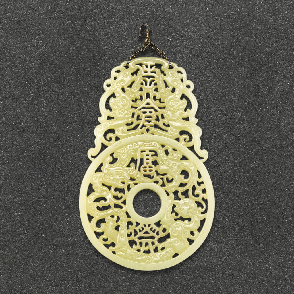 View full screen - View 1 of Lot 587. A YELLOWISH-CELADON JADE 'CHANGMING FUGUI' PLAQUE QING DYNASTY OR LATER | 清或更晚 黃青玉透雕夔鳳紋「長命富貴」珮.