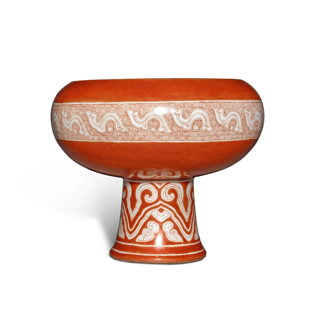 View full screen - View 1 of Lot 375. An archaistic iron-red-decorated stem bowl, Qing dynasty, 19th century | 清十九世紀 礬紅彩仿古紋豆 《周齊豆》《□□□□仿古》款.