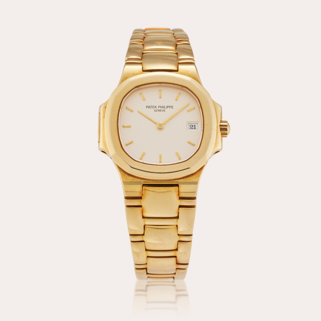 View full screen - View 1 of Lot 411. Reference 4700/51 Nautilus | A yellow gold wristwatch with date and bracelet, Circa 1990.