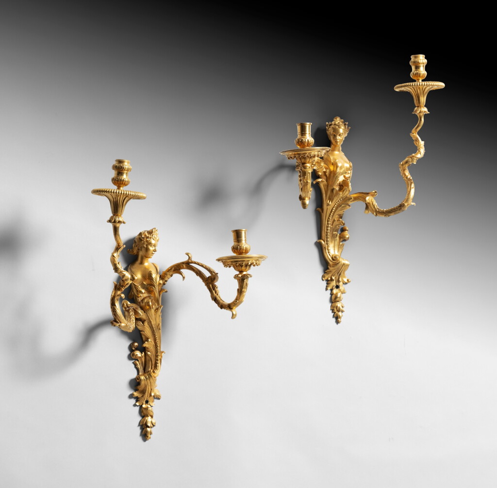 View full screen - View 1 of Lot 13. A pair of wall lights, Louis XV, circa 1730, after a design by Gilles-Marie Oppenord | Paire d'appliques en bronze doré d'époque Louis XV, vers 1730, d'après un modèle de Gilles-Marie Oppenord.