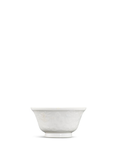 View full screen - View 1 of Lot 35. A moulded white-glazed 'peony and prunus' bowl, Qing dynasty.