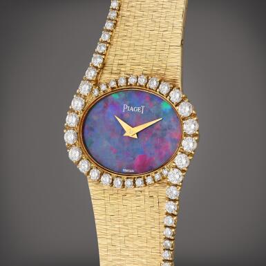 View full screen - View 1 of Lot 320. Reference 4317 A 6 | A yellow gold and diamond-set bracelet watch with opal dial, Circa 1980.