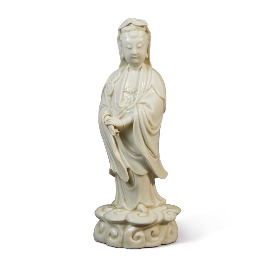 View full screen - View 1 of Lot 1035. A 'DEHUA' FIGURE OF GUANYIN STANDING ON A CLOUD, QING DYNASTY, 18TH CENTURY.