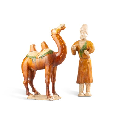 View full screen - View 1 of Lot 1055. A sancai-glazed pottery figure of a camel and A sancai-glazed pottery figure of a groom, Tang dynasty or later | Figure d'un chameau et figure de conducteur debout en grès à glaçure sancai, dynastie Tang ou postérieure.