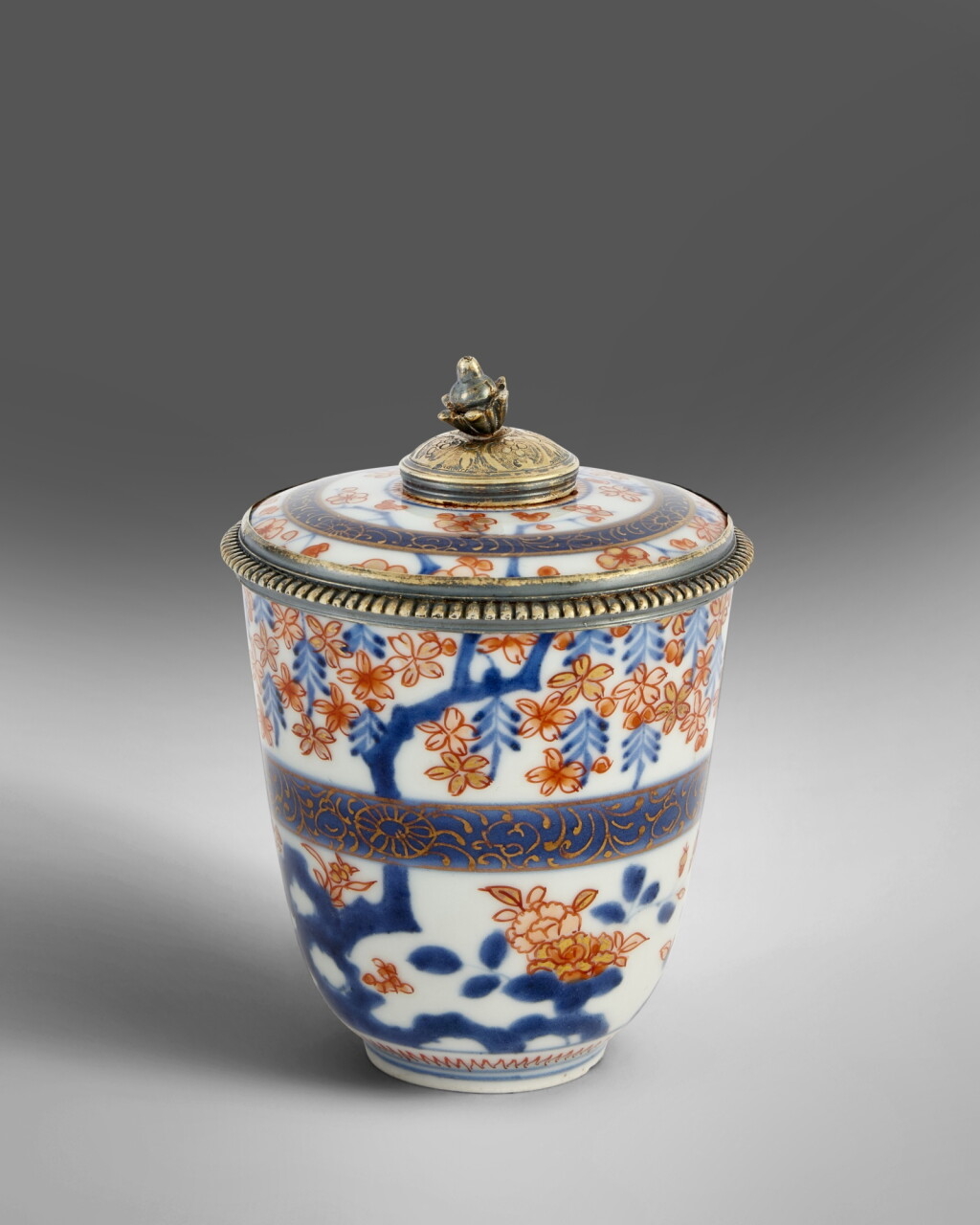 View full screen - View 1 of Lot 506. A Régence Silver-Gilt-Mounted Imari Porcelain Covered Beaker, Paris, 1717-22 .