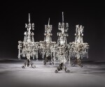 A set of four Régence style bronze and cut-glass twelve-light candelabra | Ensemble de quatre candélabres à douze lumières en bronze et verre taillé de style Régence