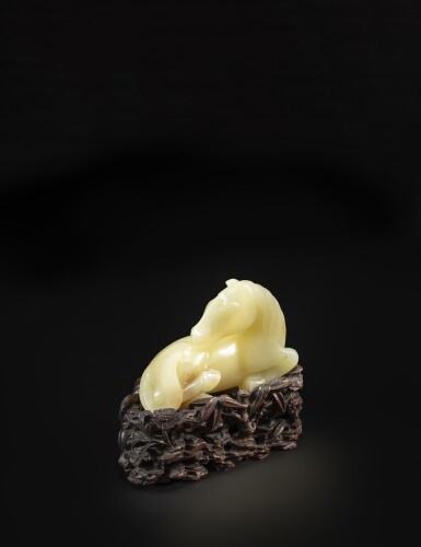 View full screen - View 1 of Lot 57. A yellow jade recumbent horse, Qing dynasty, Qianlong period | 清乾隆 黃玉臥馬擺件.