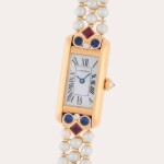 Tank Allongée, Reference 13801 | A yellow gold, pearl, ruby, sapphire and diamond-set bracelet watch with mother-of-pearl dial | Circa 1985