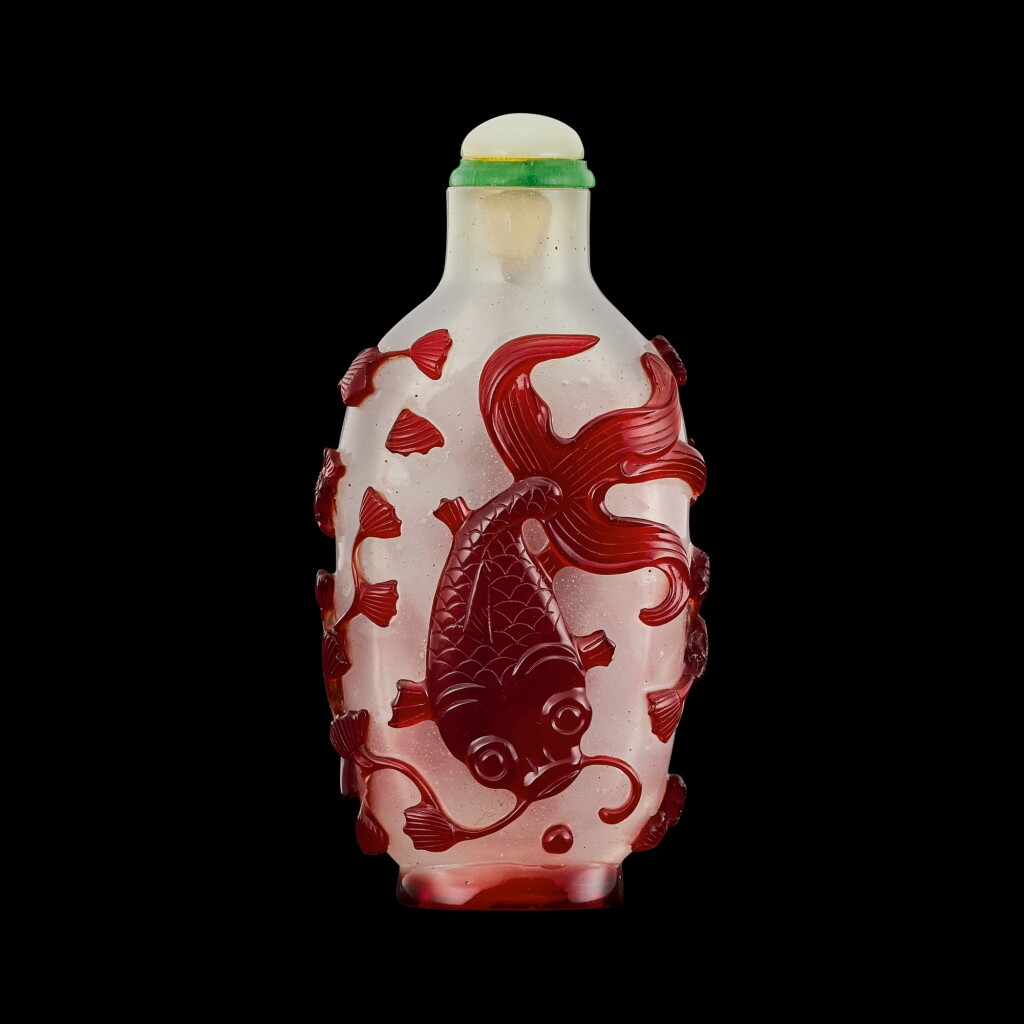 View full screen - View 1 of Lot 1082. A red overlay white glass 'fish' snuff bottle Qing dynasty, 18th - 19th century | 清十八至十九世紀 白地套紅料鯰魚圖鼻煙壺.