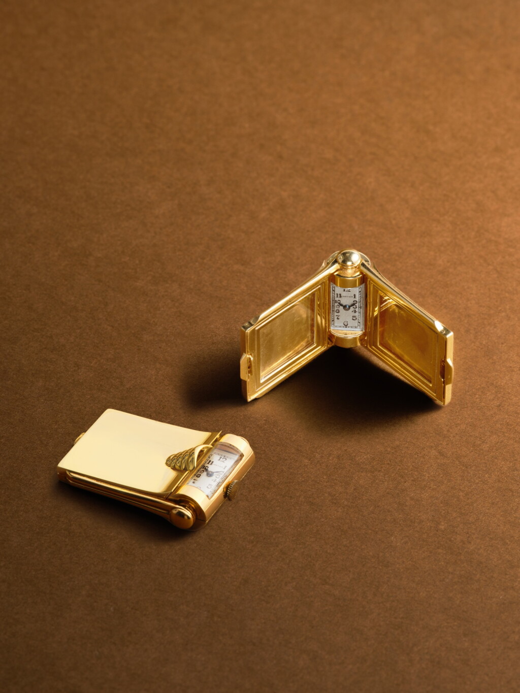 View full screen - View 1 of Lot 2138. A yellow gold miniature diptych-form photo frame with integrated revolving watch case, Circa 1945 .