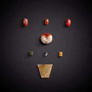 View full screen - View 1 of Lot 7859. Seven jade and hardstone beads and a jade 'mask' pendant, Eastern Zhou dynasty | 東周 玉石珠飾七件及青玉獸面紋珮.