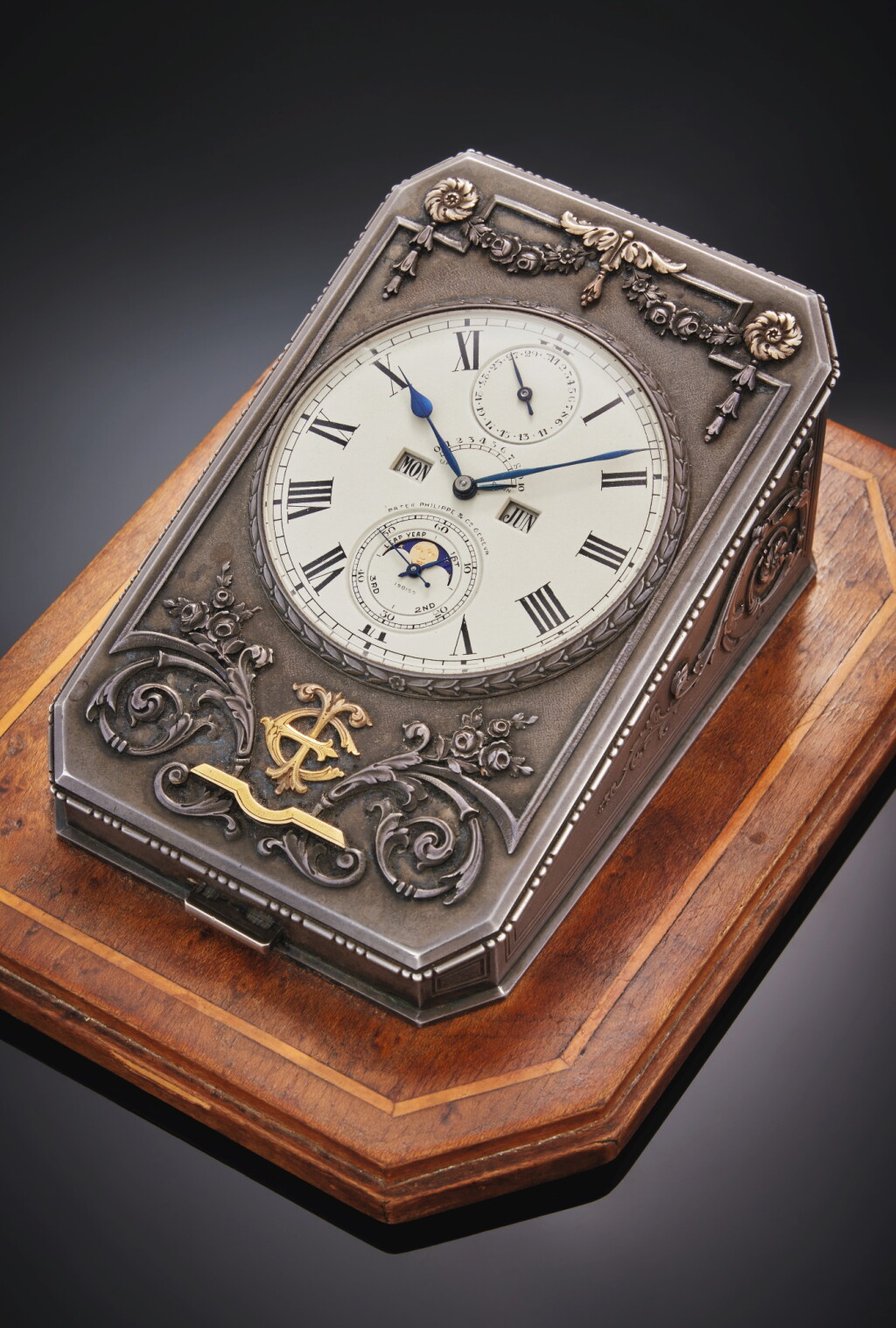 View full screen - View 1 of Lot 32. A historically important and previously unknown Ten-Day silver and gold two-train ‘Presse-Papier’ desk timepiece with perpetual calendar, moon phases, and 10-day up-down indication with wood base, Mvt. 198159, Case 292119, Made for Thomas Emery, Made in 1928 and Sold in 1933.