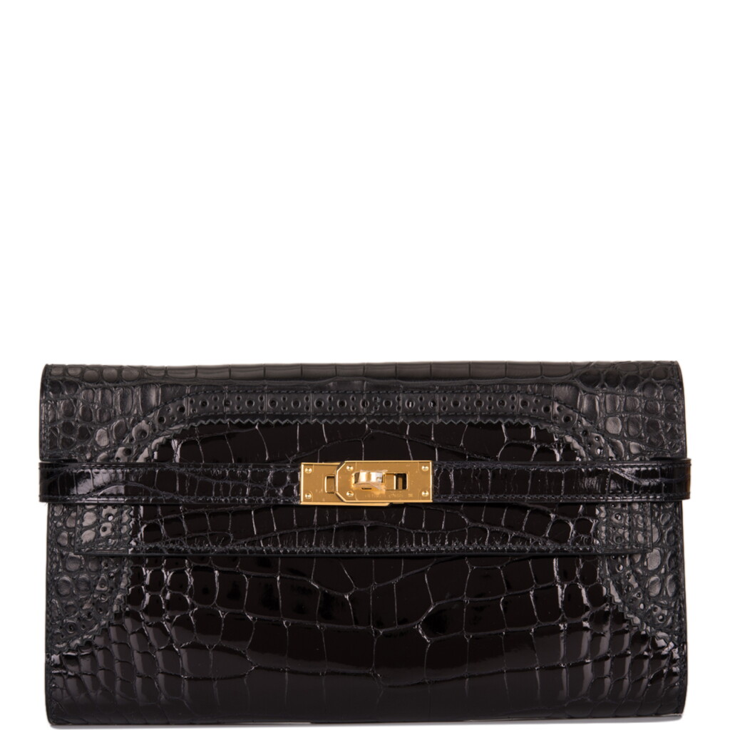 View full screen - View 1 of Lot 49. Hermès Kelly Long Ghillies Wallet of Black Shiny Mississippiensis Alligator with Gold Hardware.