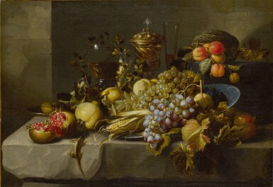 View full screen - View 1 of Lot 26. Still Life of grapes, pomegranates, walnuts, peaches, an ear of corn, various drinking vessels, and a lizard, all on a stone ledge.