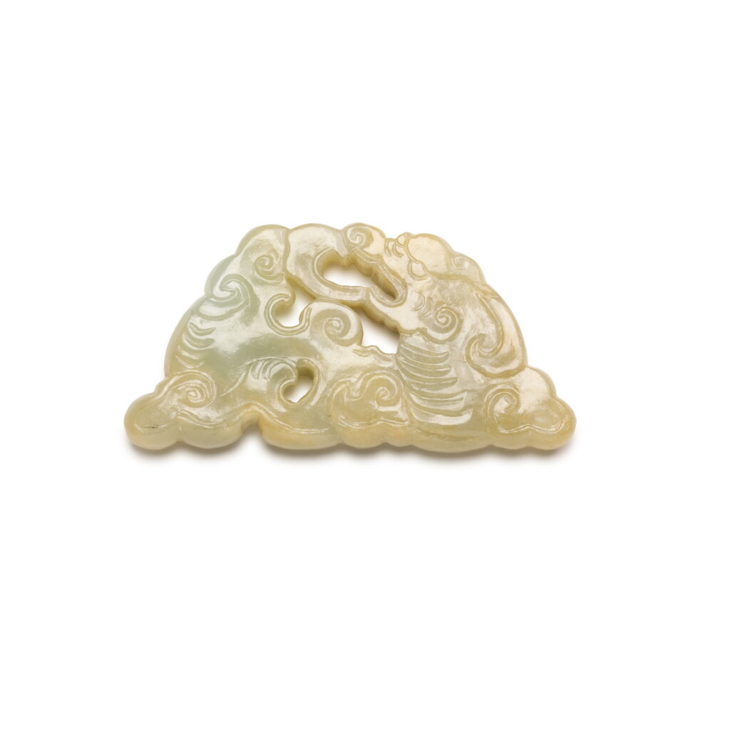 View full screen - View 1 of Lot 217. A PALE CREAM AND CELADON JADE 'DRAGON' PENDANT, 17TH/18TH CENTURY | 十七/十八世紀 青玉龍紋珮.