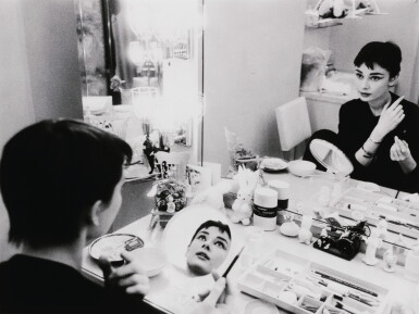 View full screen - View 1 of Lot 136. Audrey Hepburn at make up table in two mirrors (for 'Mademoiselle'), 1954.