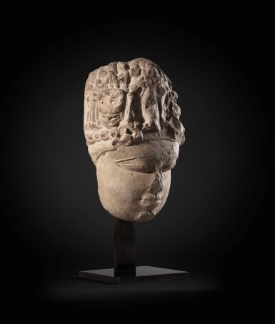 View full screen - View 1 of Lot 243. A monumental buff sandstone head of a Devi North India, 9th-10th century | 印度北部 九至十世紀 砂岩雕提毗首.