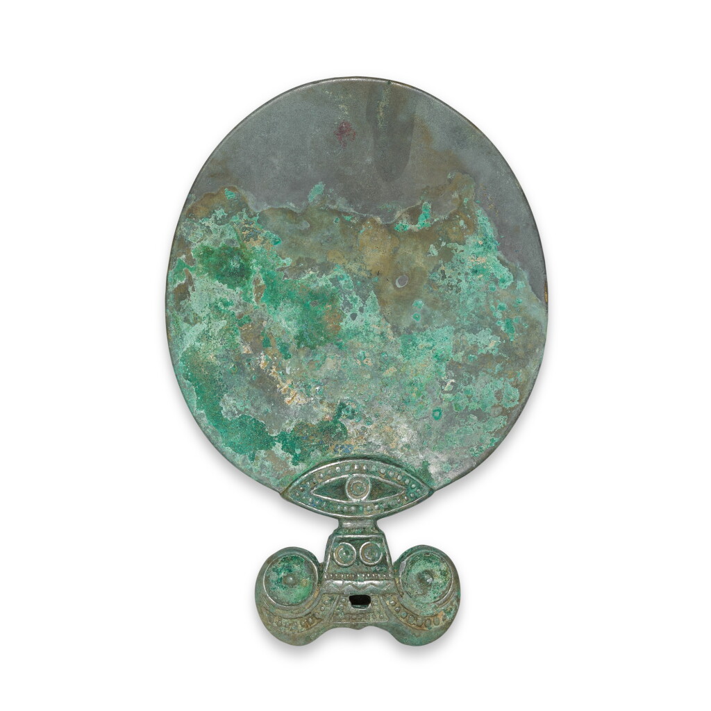 View full screen - View 1 of Lot 418. An archaic bronze hand mirror, Han dynasty | 漢 青銅鏡.