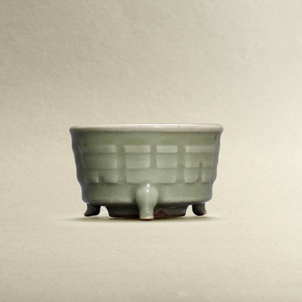 View full screen - View 1 of Lot 5766. A Longquan celadon-glazed 'trigram' tripod incense burner, Yuan dynasty | 元 龍泉青釉八卦紋筒式三足爐.