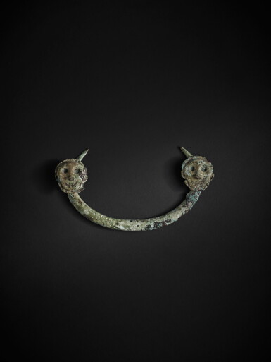 View full screen - View 1 of Lot 223. A rare archaic bronze 'figural' ornament, North China, 11th - 10th century BC | 中國北部 公元前十一至十世紀 青銅人面紋飾件.