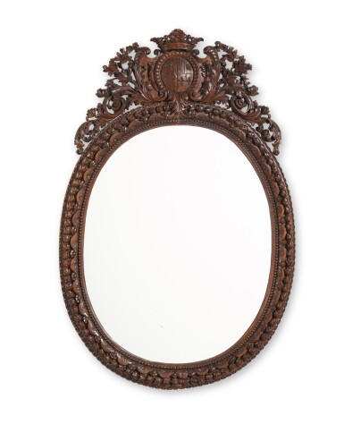 View full screen - View 1 of Lot 14. A Dutch carved walnut armorial oval mirror, circa 1720.