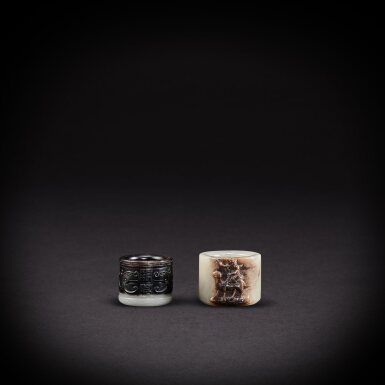 View full screen - View 1 of Lot 6941. A yellow jade 'foreigner' thumb ring and an inscribed pale yellow jade 'kuilong' thumb ring, Qing dynasty, 18th century | 清十八世紀 黃玉胡人扳指及青黃玉夔龍紋「乾坎」扳指.