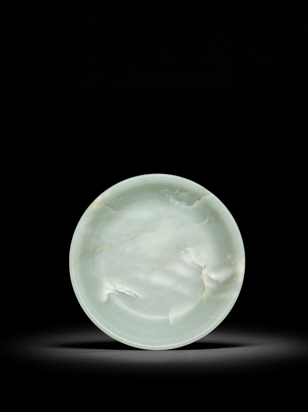 View full screen - View 1 of Lot 22. A large pale celadon jade dish, Qing dynasty, 18th century | 清十八世紀 青白玉大盤.